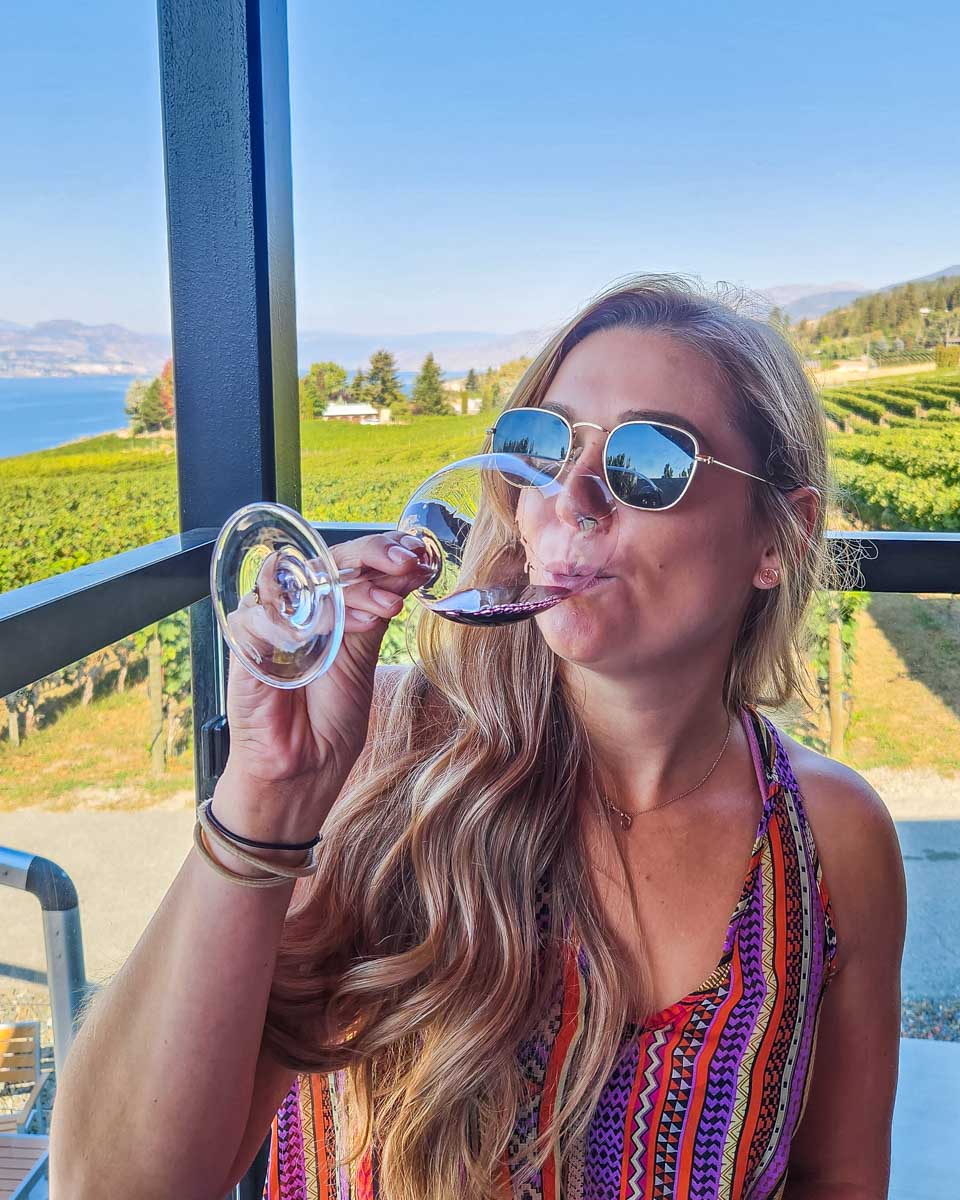 Bailey sips wine at a winery on a wine tour in Naramata Bench, Penticton