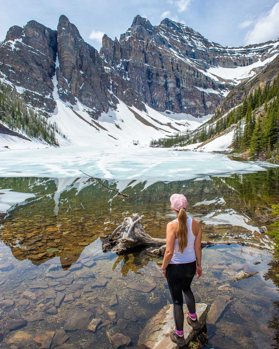 Bailey stands on the edge of Lake Agnes on the Lake Agnes Teahouse hike