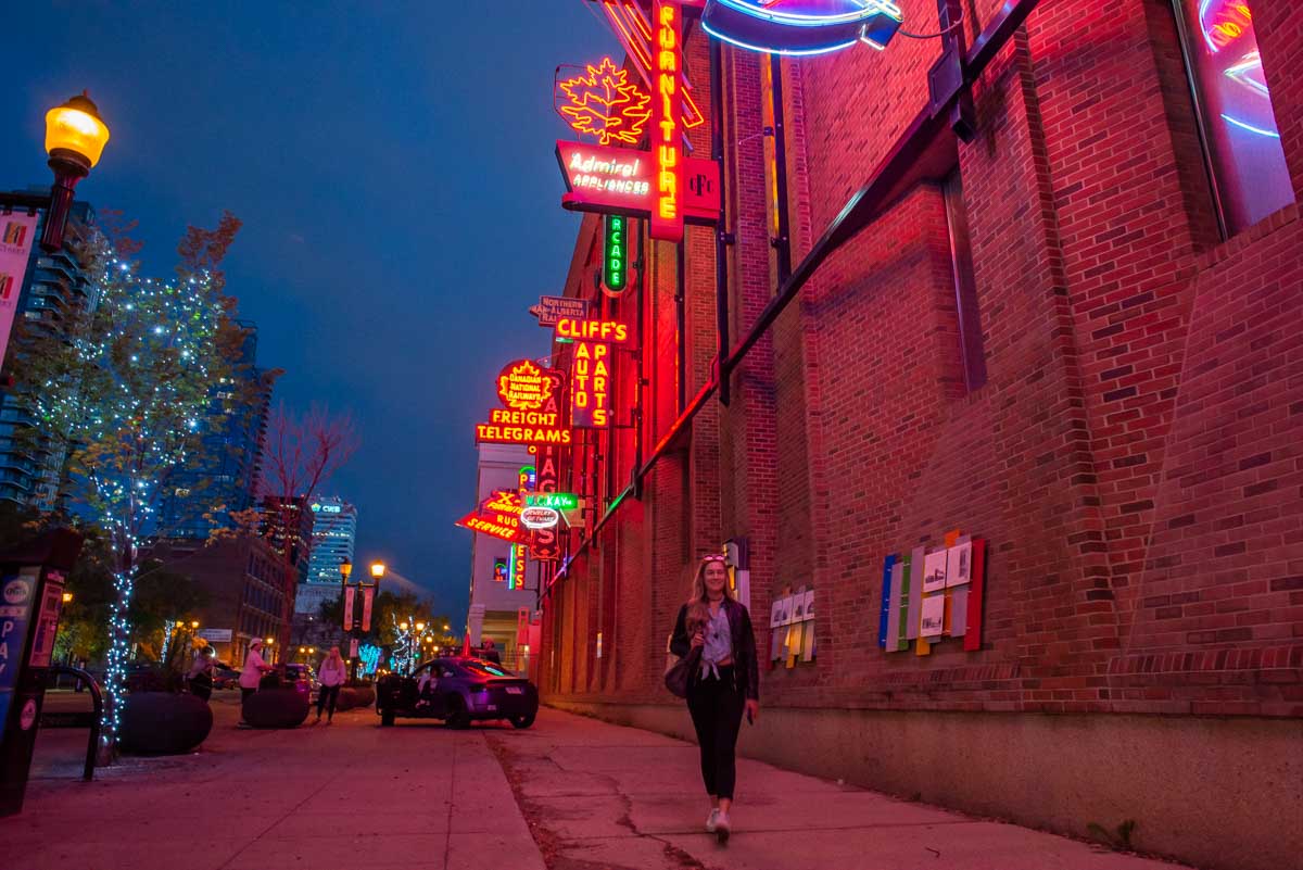 Bailey walks along the Neon Sign Museum in Edmonton, Alberta