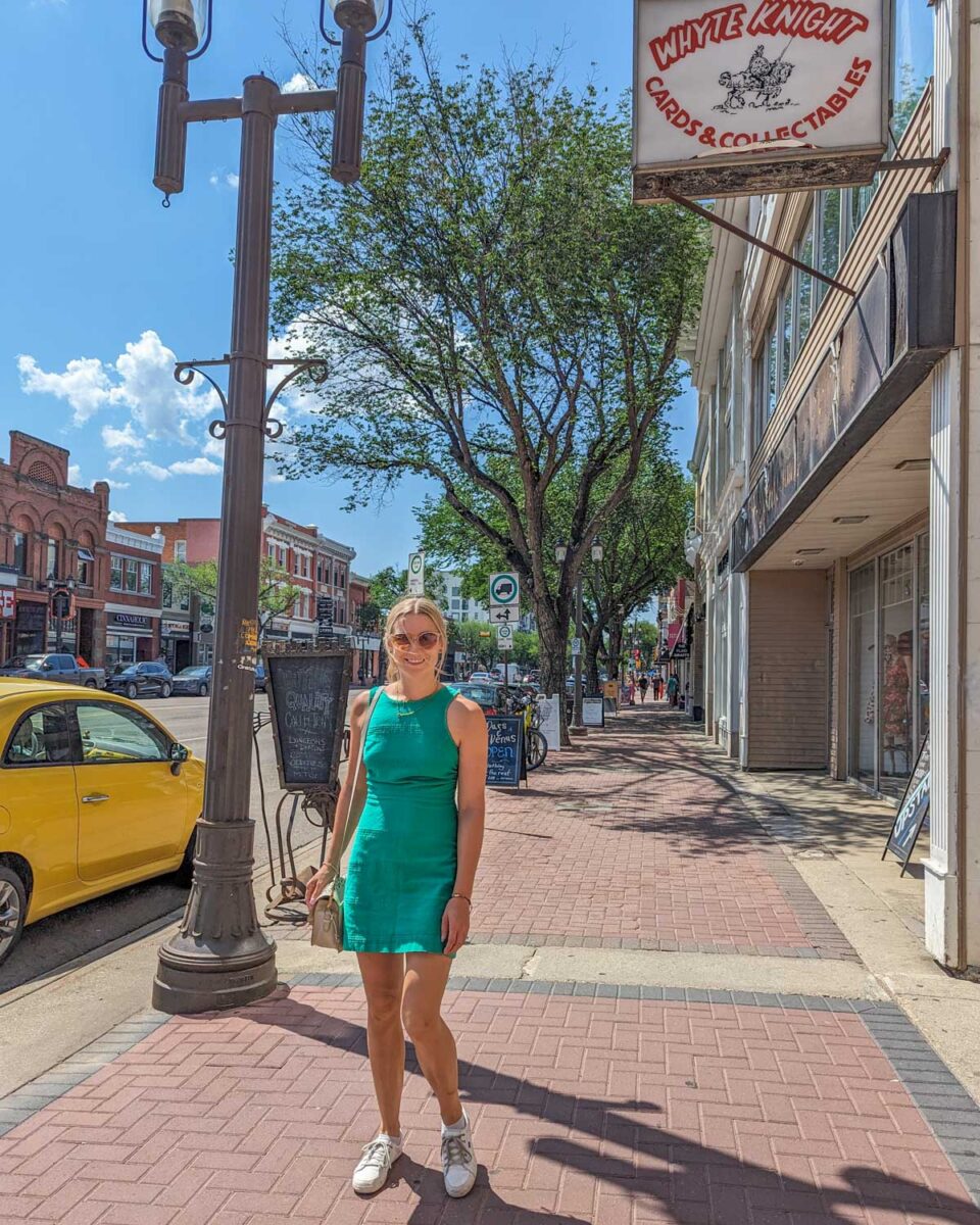 Bailey walks down the street of Whyte Ave on a sunny day