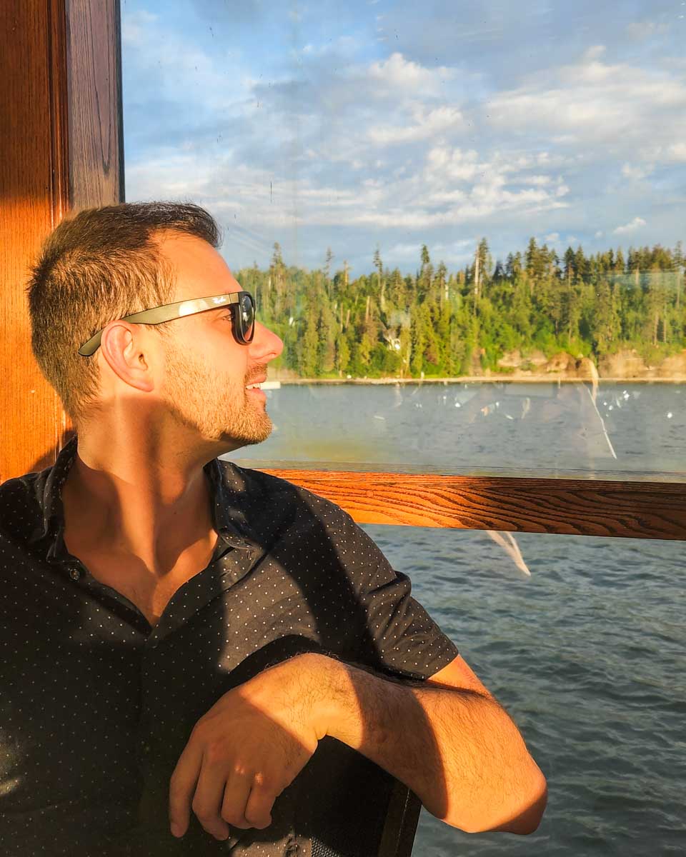 Daniel looks out the window on a sunset cruise in Vancouver