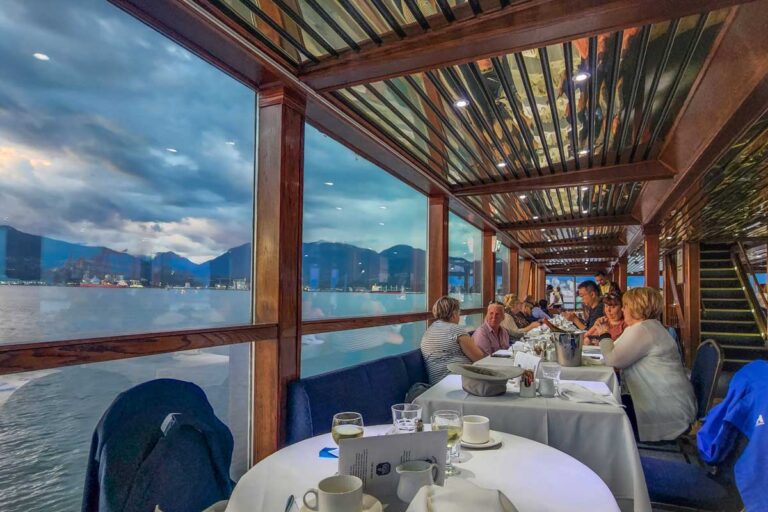 Tables with views out the windoes on a sunst cruise in Vancouver, Canada
