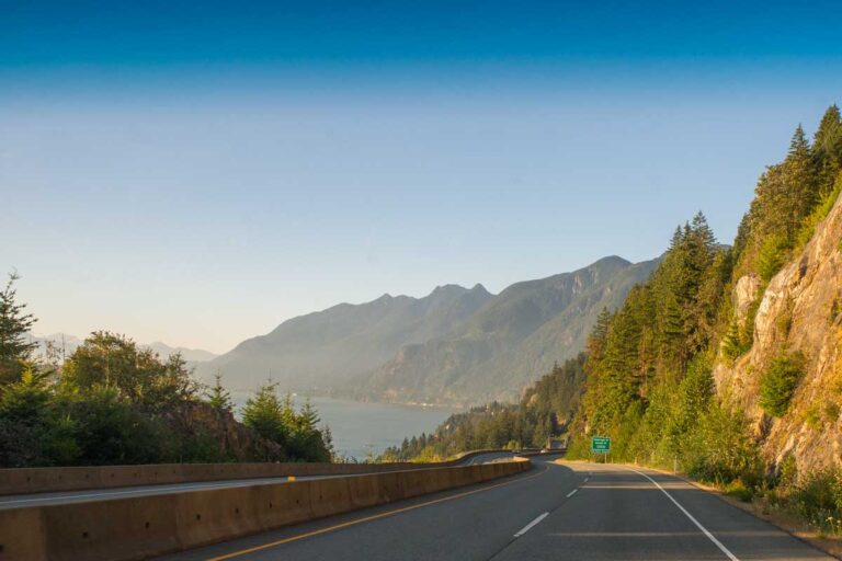 View from the front of a car driving on the Sea to Sky Highway between Vancouver and Whistler at sunset