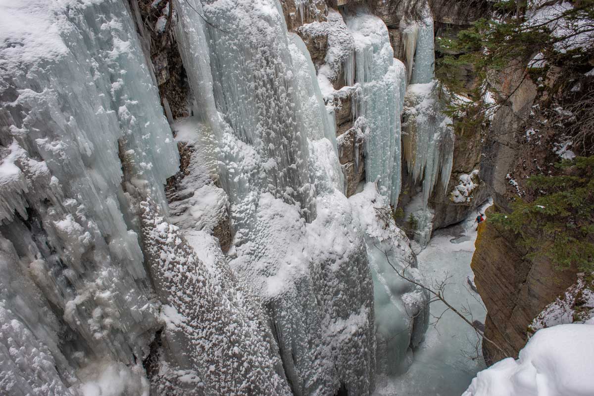 View from the top of Maligne Canyon looking down a frozen waterfall in winter
