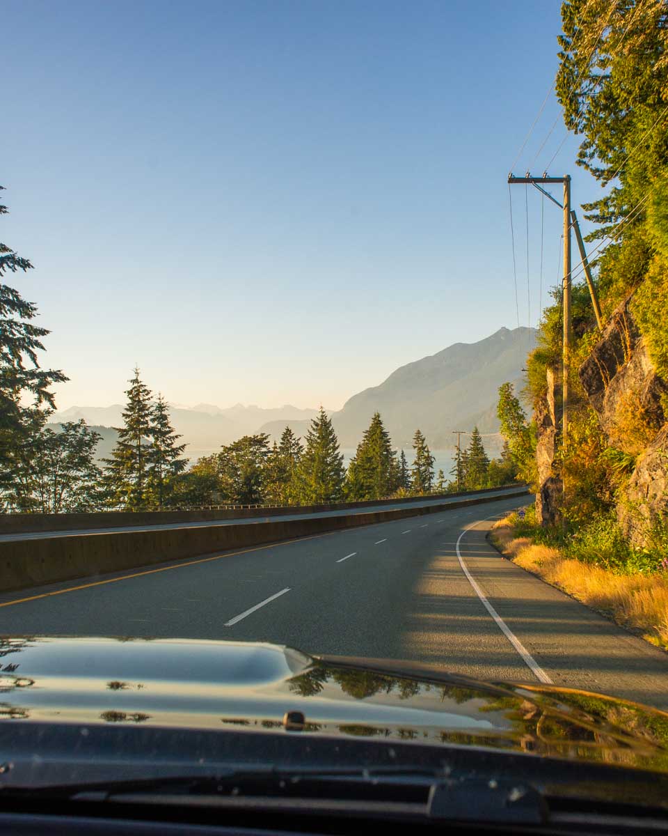 View out the window of a car on the Sea to Sky highway outside of Vancouver at sunset