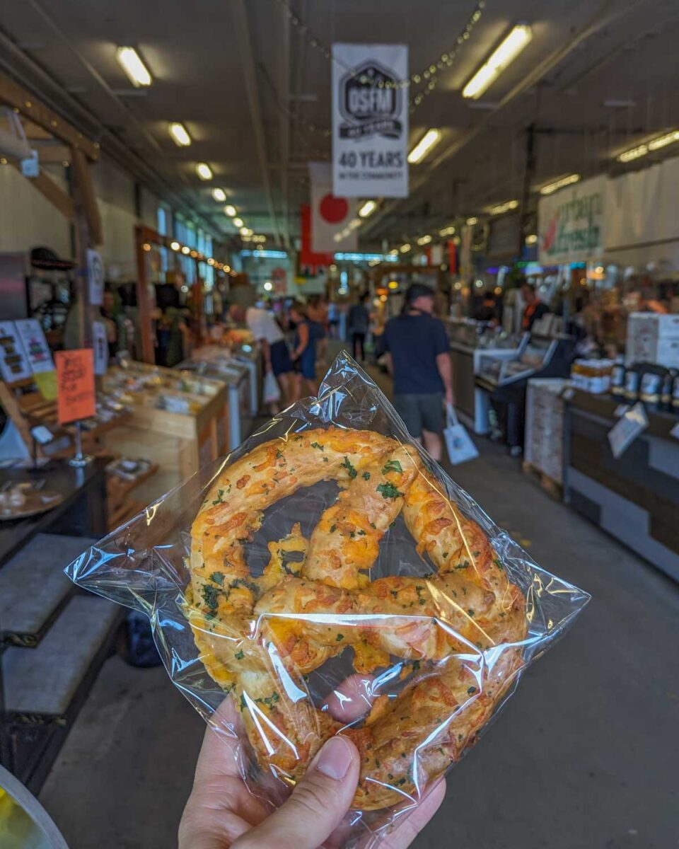 a pretzel covered in cheese and jalepenos from Strathcona Farmers market