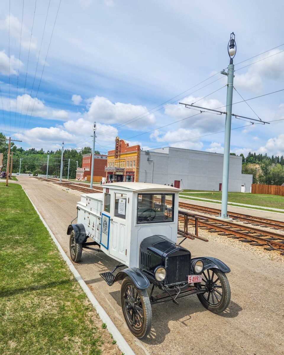 an old truck parked on a street in Fort Edmonton Park