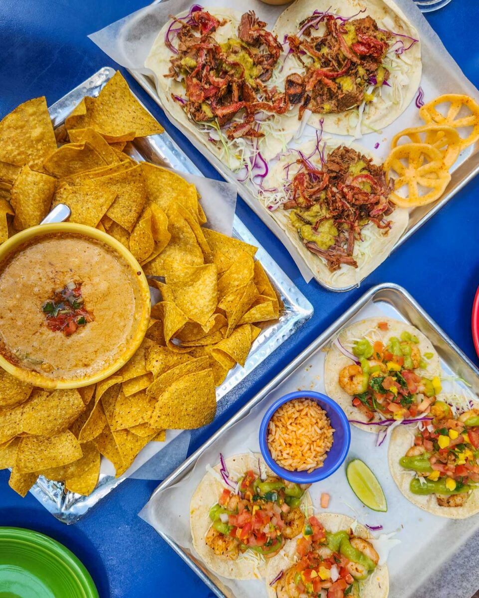 three plates of mexican food from Julios Barrio in Edmonton