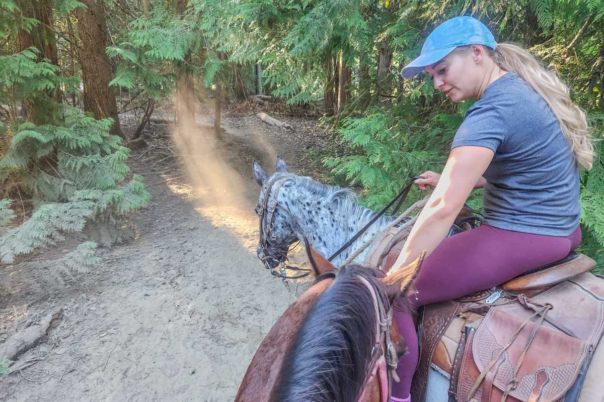 Bailey pets a horse in Banff National Park on a horseback riding tour (2)