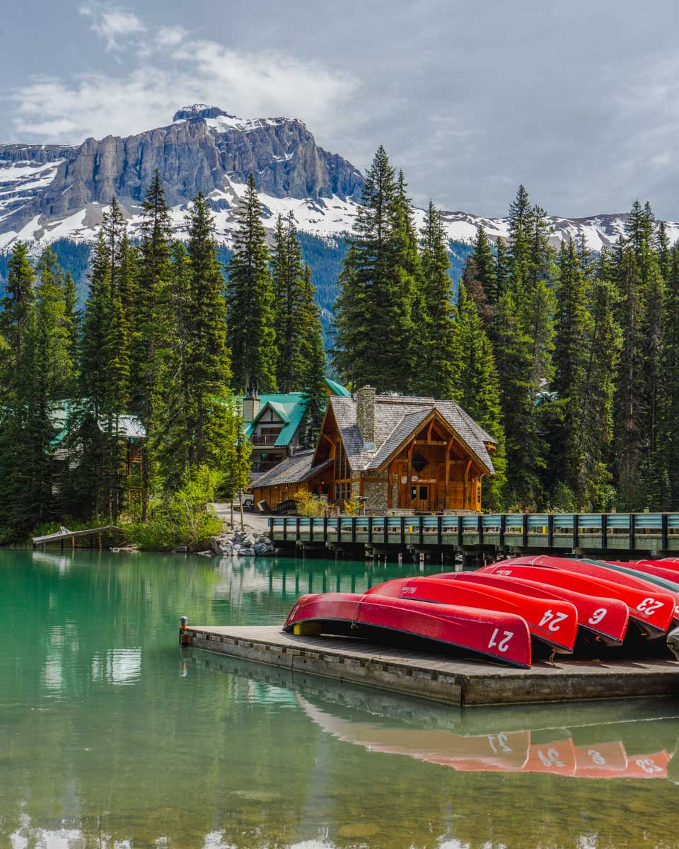 Canoes and the Emerald Lake Lodge at Emerald Lake in Yoho National Park, Canada