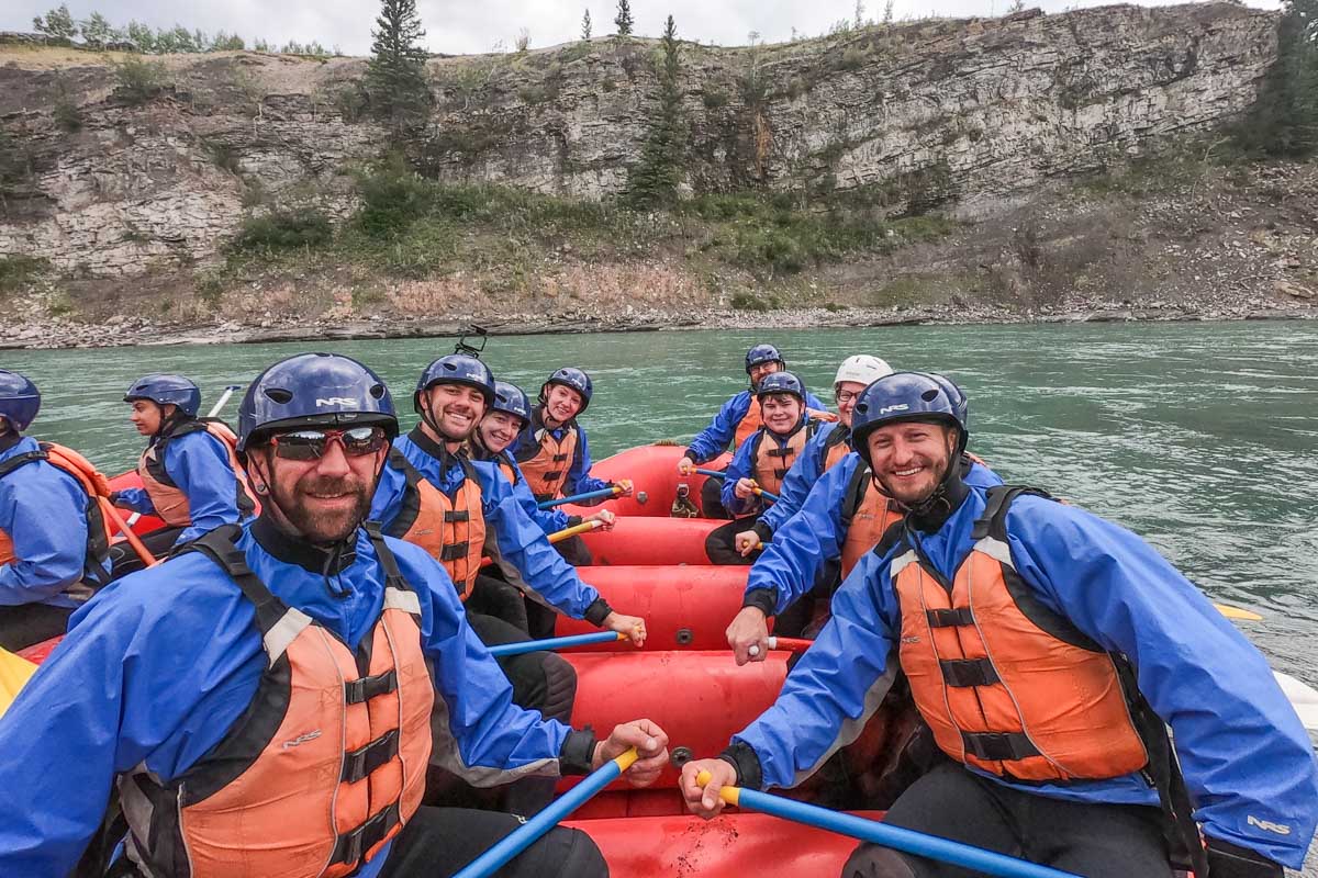 The entire team on a raft get a photo in between rapids in Banff