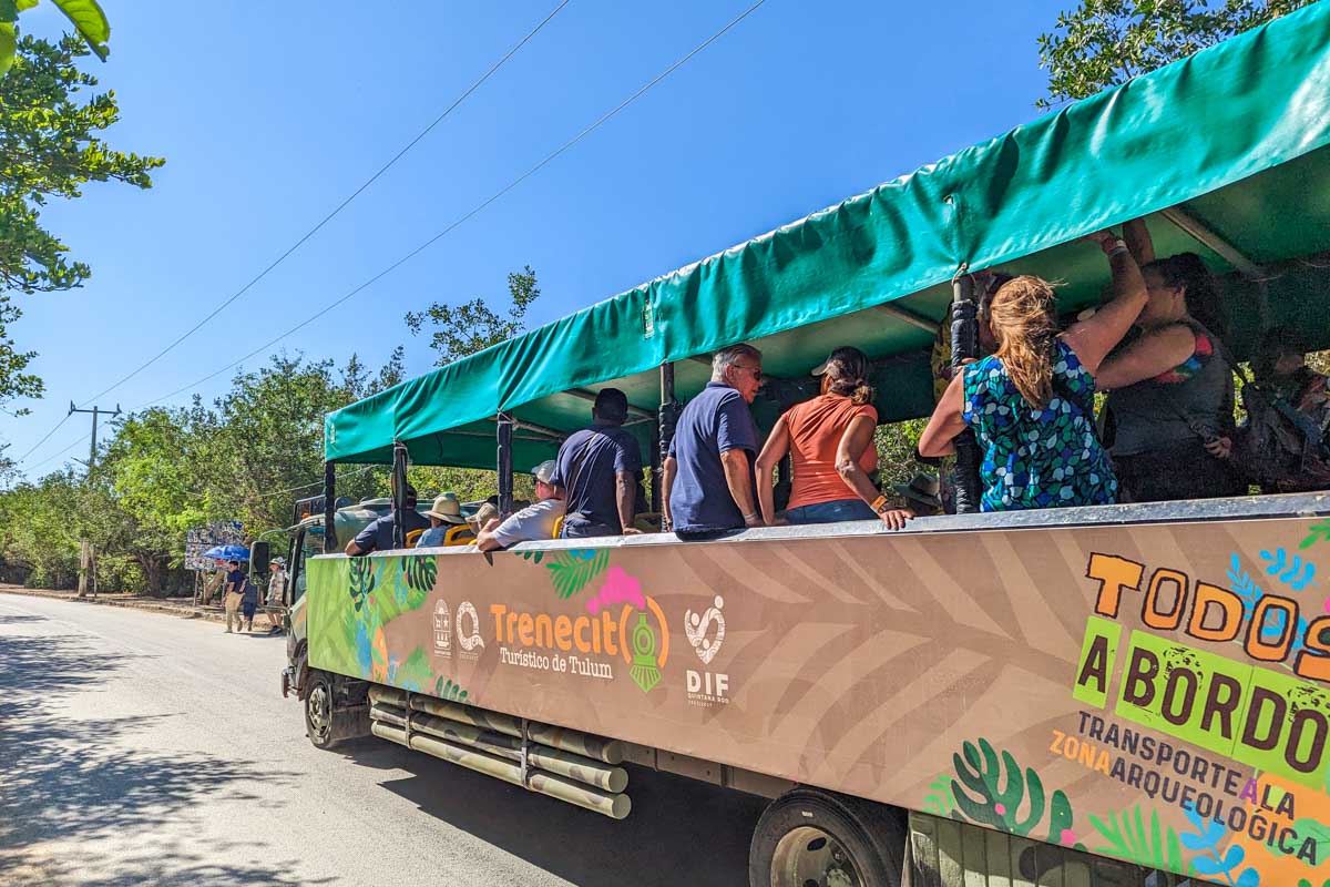 A bus takes people to the entrance of the Tulum Ruins in Mexico