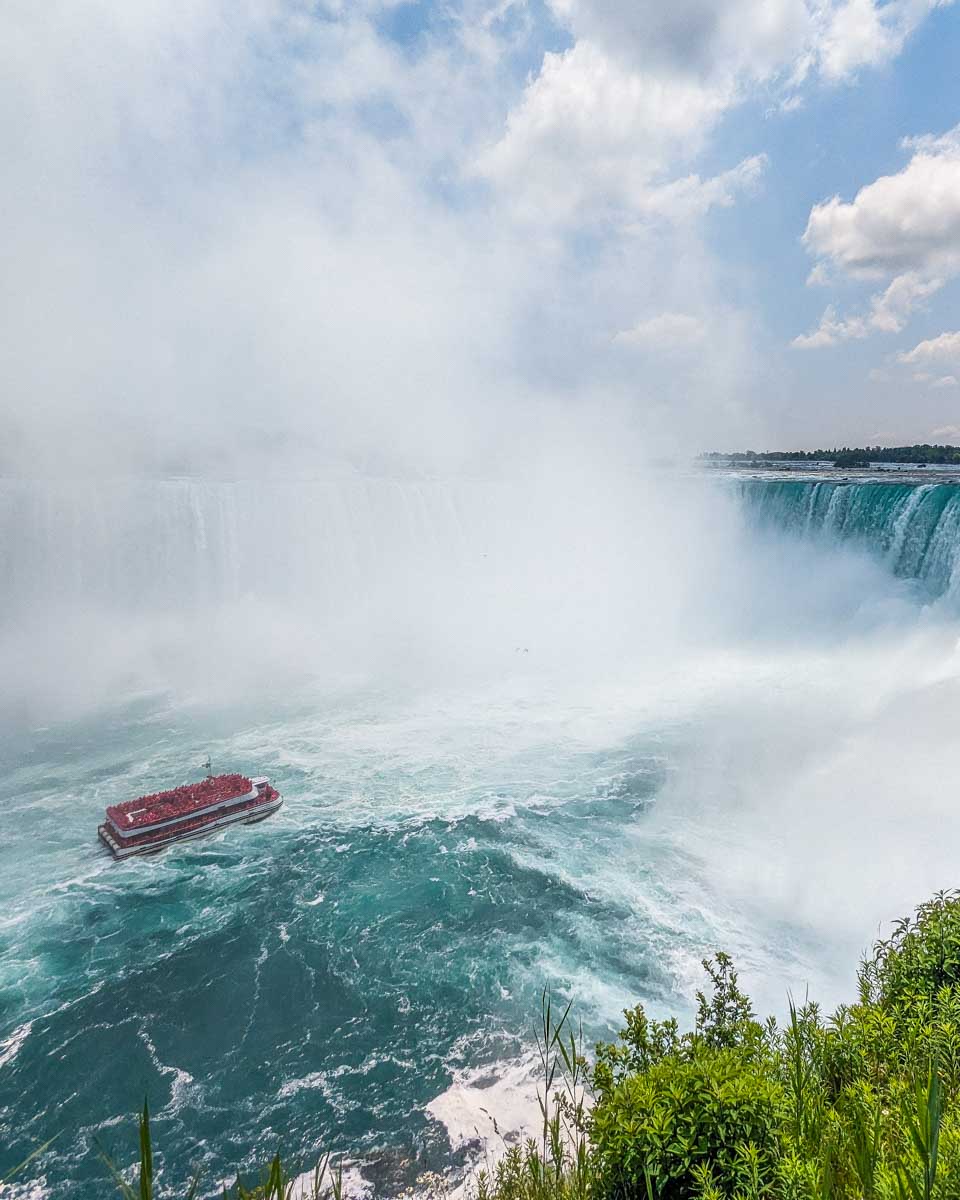 A cruise travels towards Niagara Falls as seen from above on the Canadian side of Niagara Falls