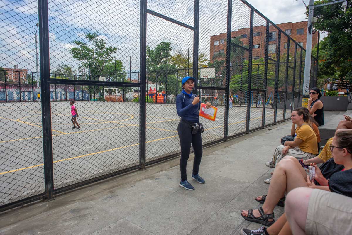 A tour guide in Comuna 13 talks ato a group of tourists in Medellin, Colombia