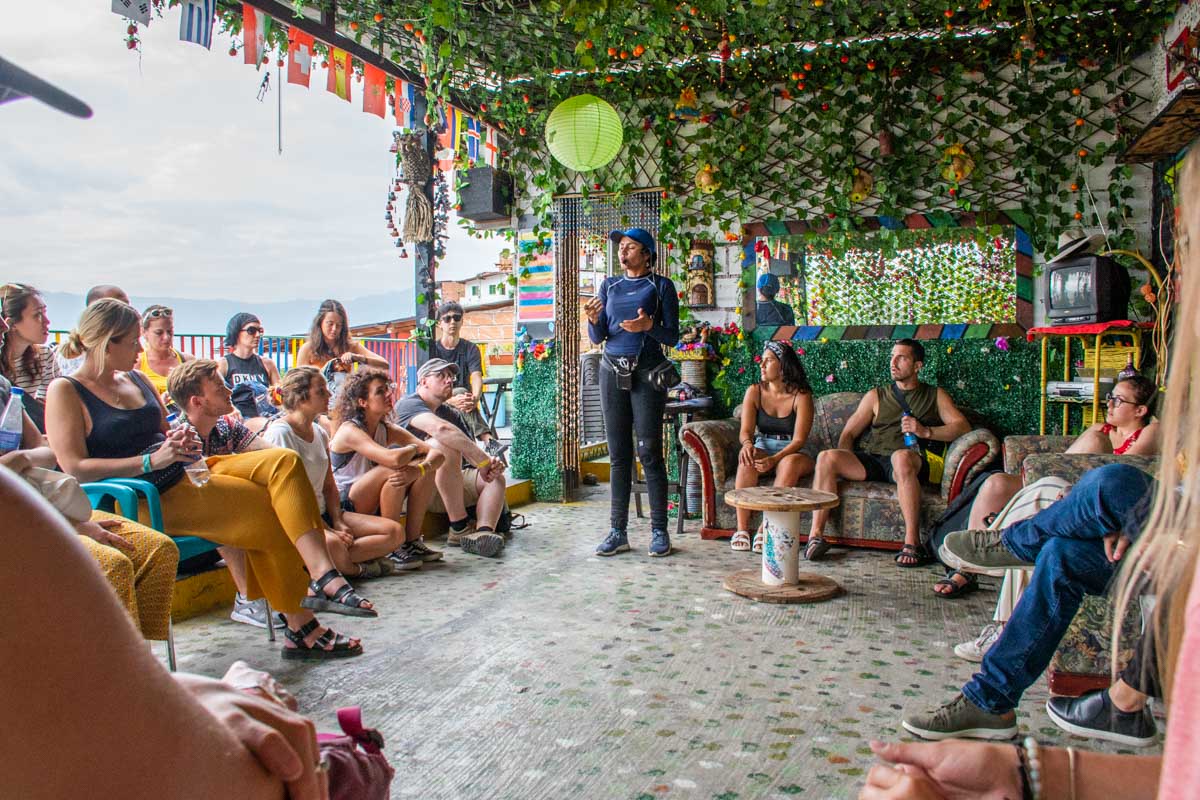 A tour guide talks to a group of tourists in Comuna 13, Medellin