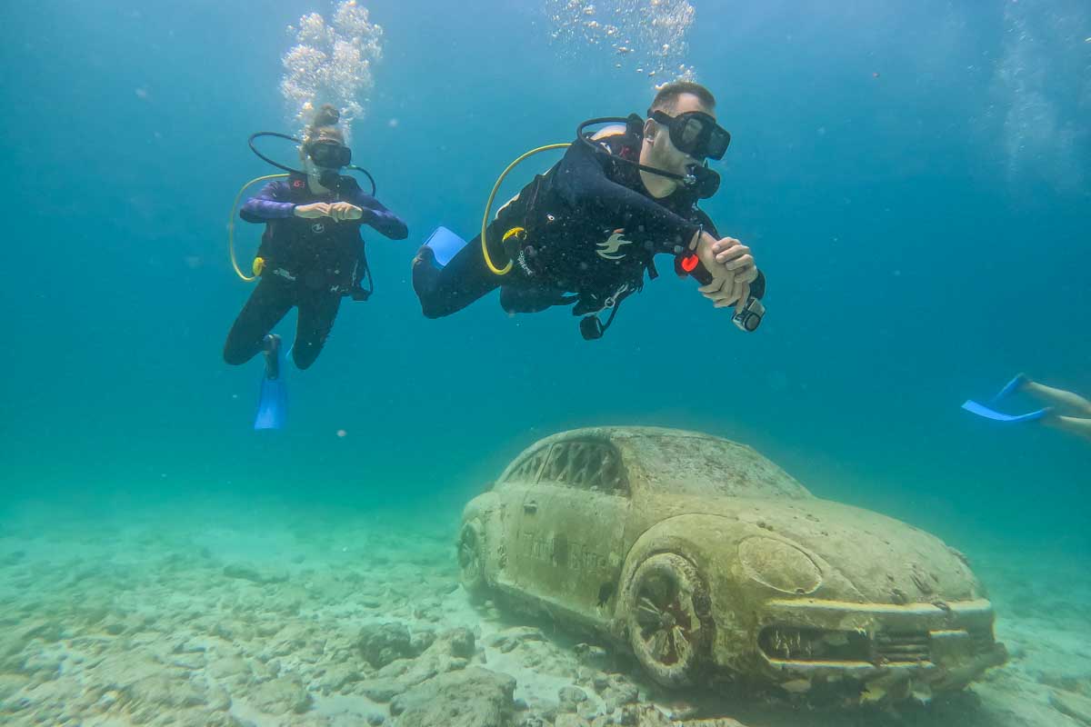 Bailey and Daniel with a car at the MUSA reef in Cancun, Mexico