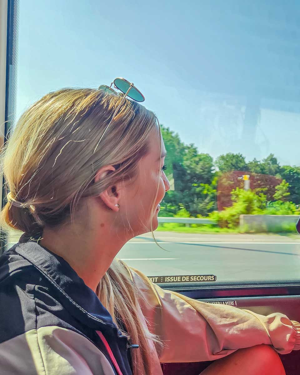 Bailey sits on the bus looking out the window on her way to Niagara Falls from Toronto on a tour