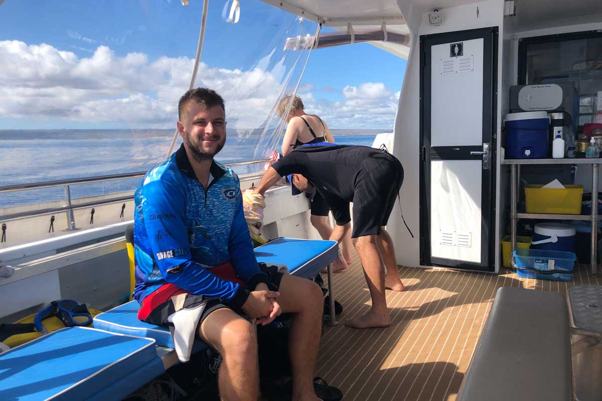 Daniel brother relaxes on the boat on his whale shark tour off the coast of Playa Del Carmen, Mexico