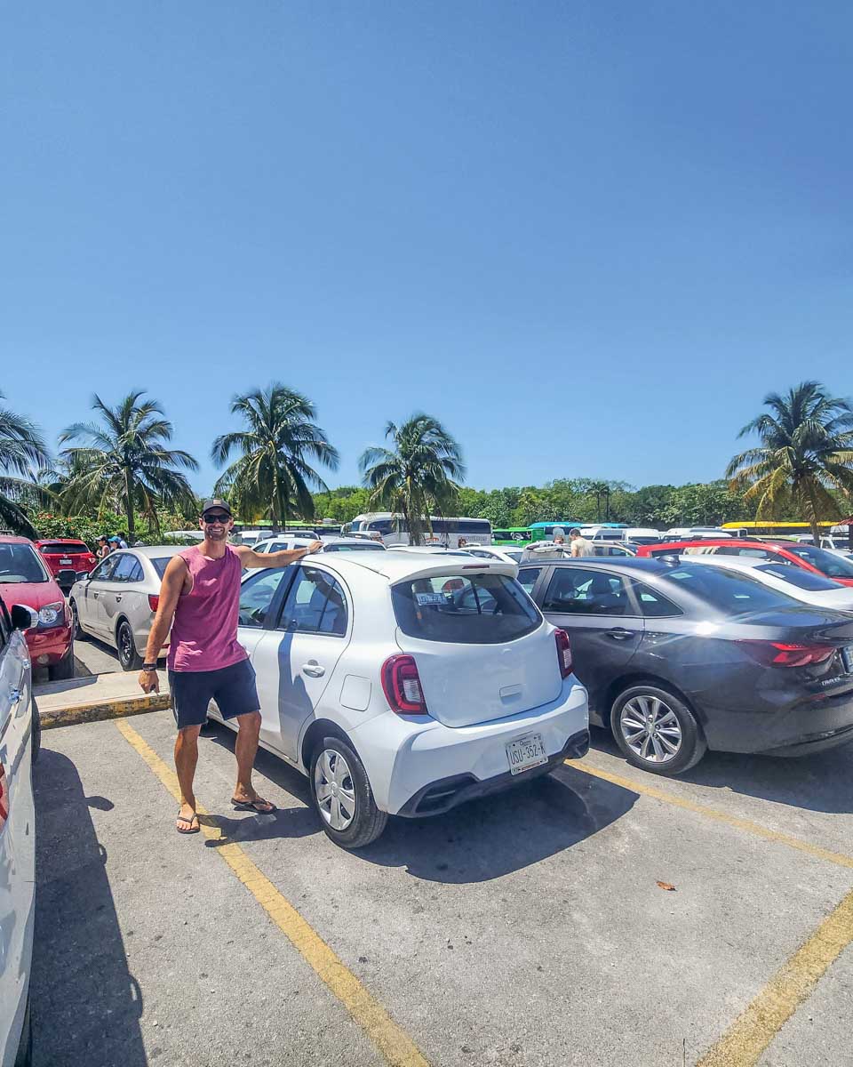 Daniel with his rental car at the Tulum Ruins main entrance parking lot in Tulum, Mexico