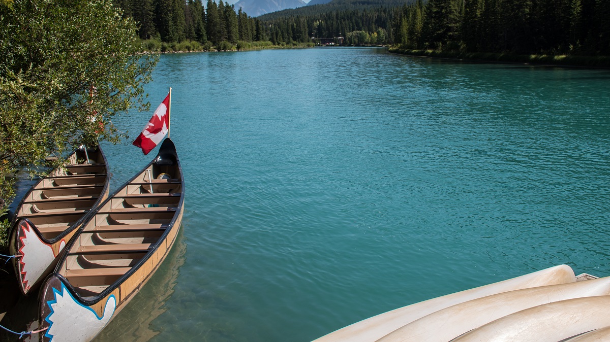 two large Canadian canoes in the Bow River in Banff