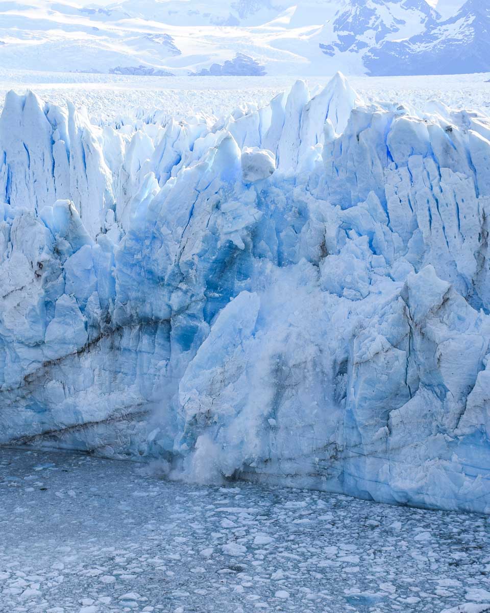 A huge chunk of ice begins to fall from the Perito Moreno Glacier in Argentina