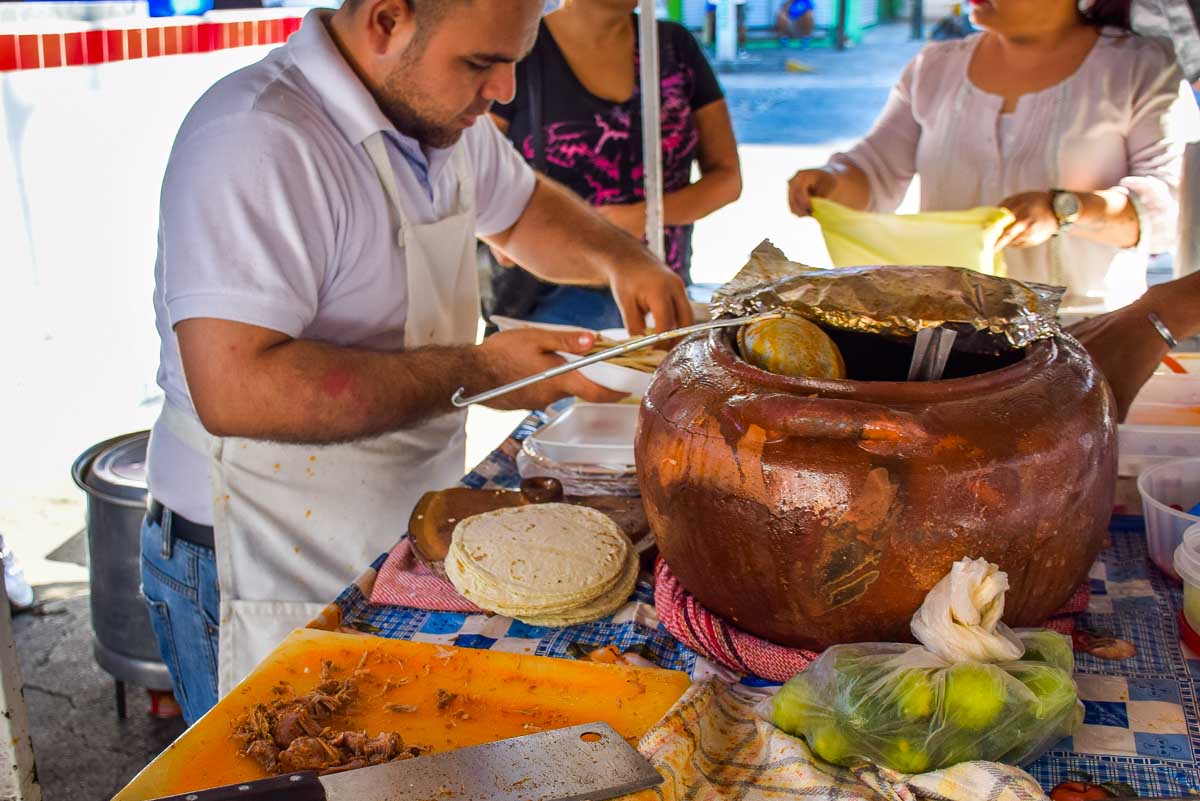 A man serves people tacos in Mexico City on a taco tour