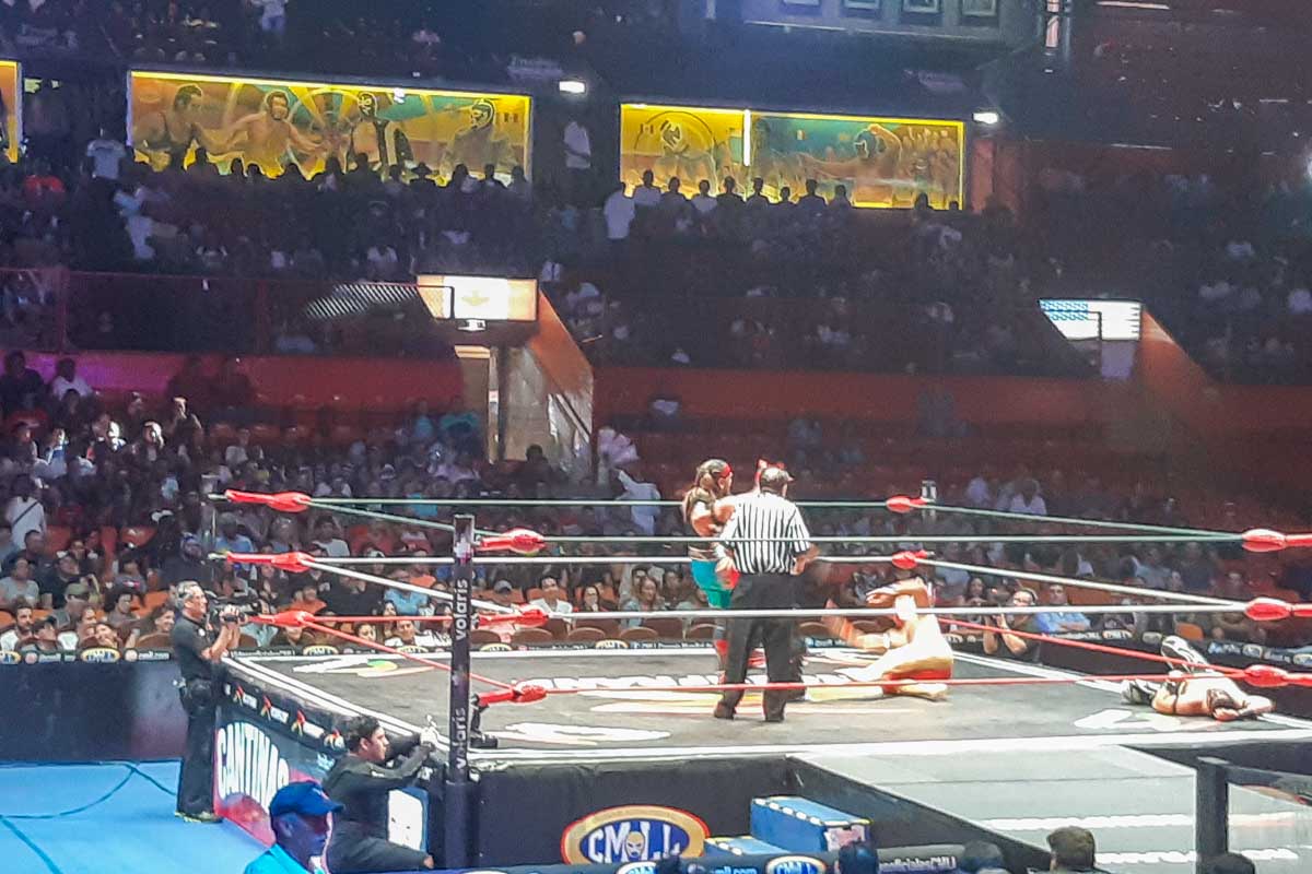 A wrestler gets thrown to the ground at a Lucha Libre wrestling show in Mexico City