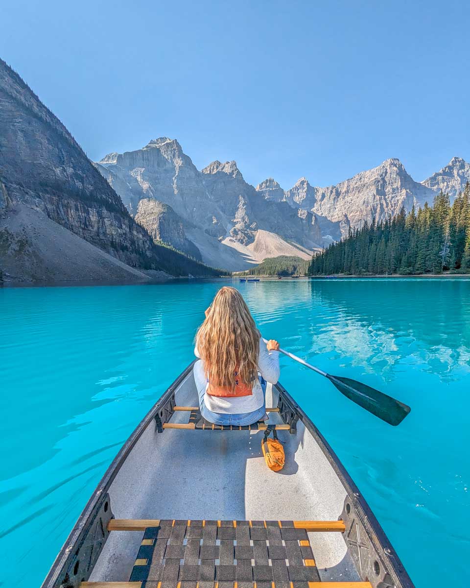 Bailey canoes on the blue water on Moraine Lake, Banff