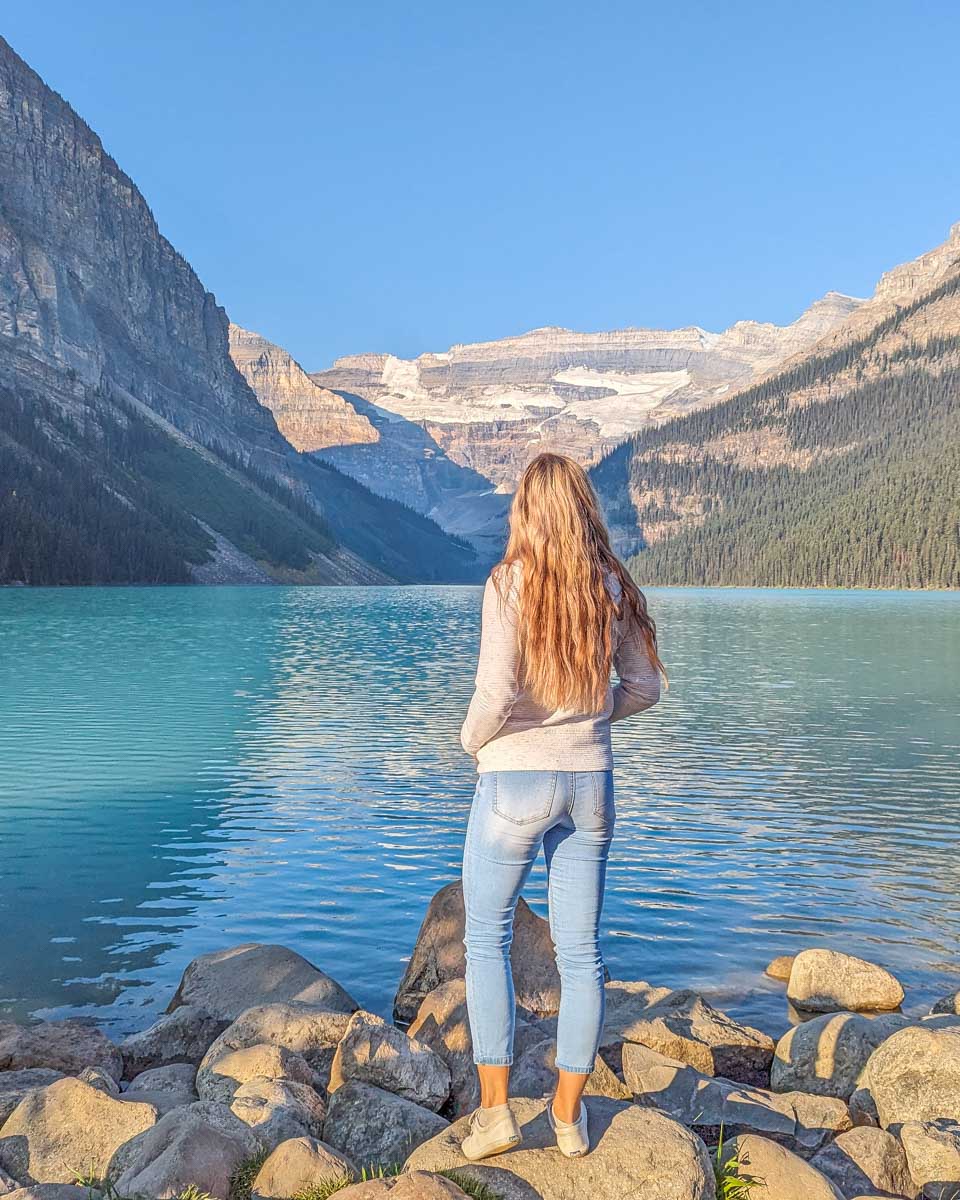 Bailey on the shores of Lake Louise at sunrise