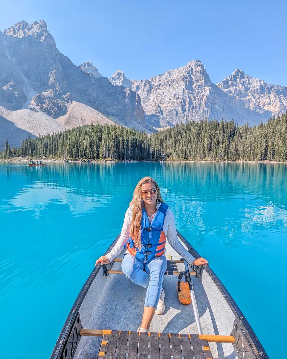 Bailey poses for a photo in a canoe in Moraine Lake