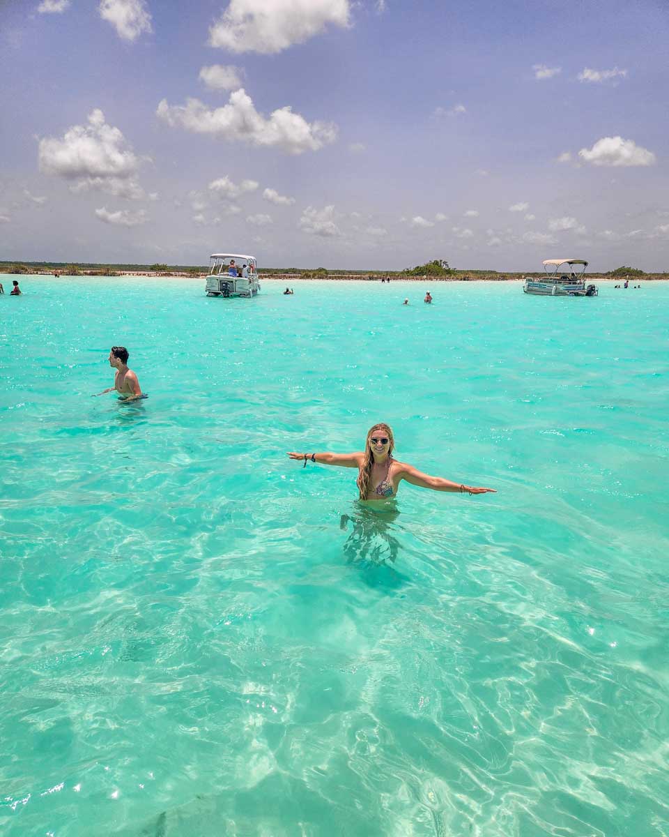 Bailey swims in the crystal clear waters of Bacalar Lagoon on a boat tour
