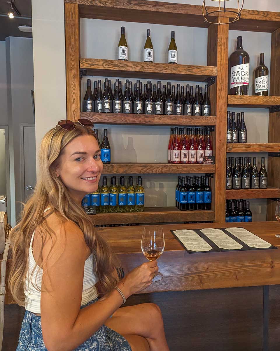 Bailey tastes wine at Backyard vineyards near Vancouver