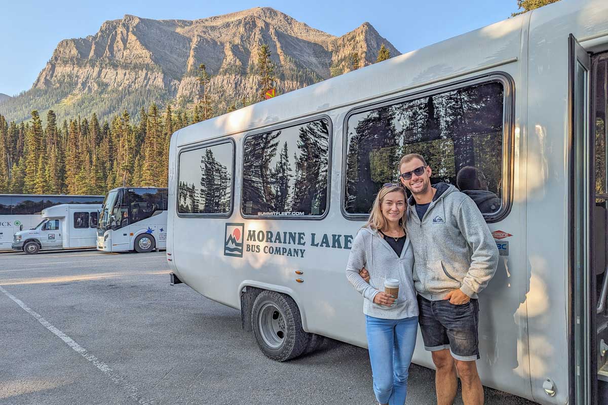 Daniel and Bailey pose for a photo with the Moraine Lake shuttle