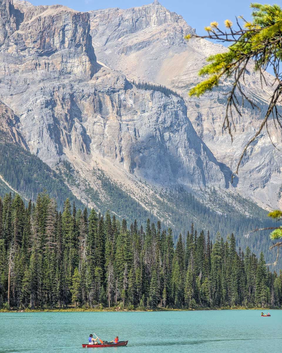People canoe with mountain views at Emerald Lake in Yoho National Park