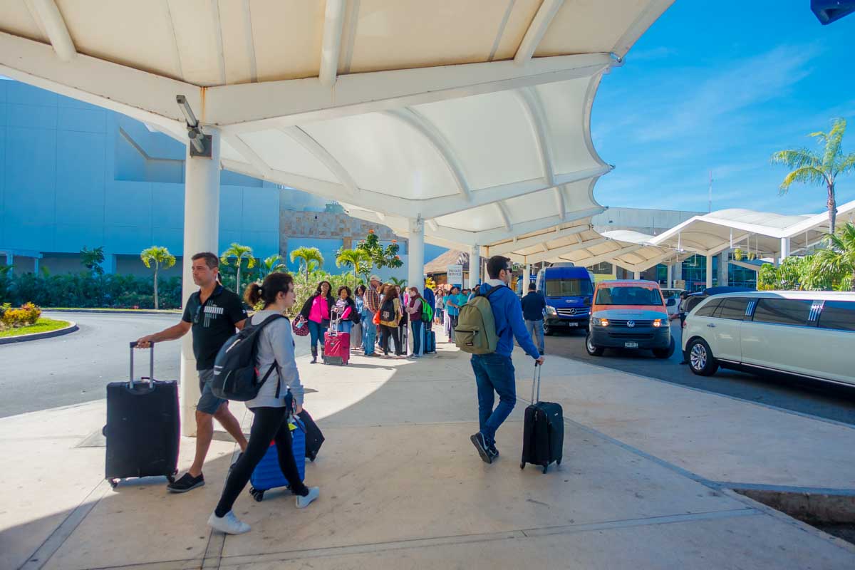 Travelers head to their shuttles at Cancun Airport in Mexico