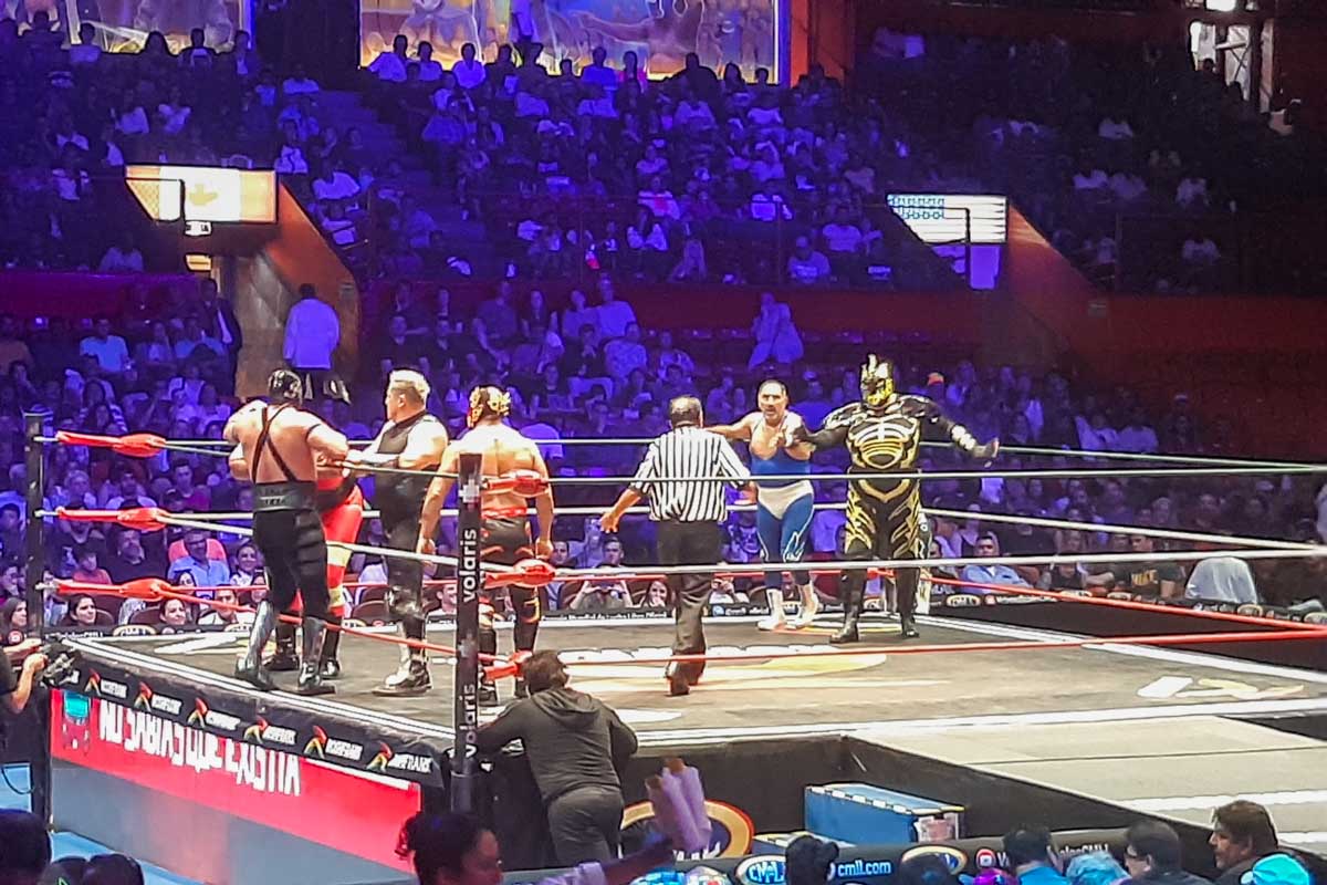 Wrestlers fighting in a ring during a Lucha Libre show in Mexico City