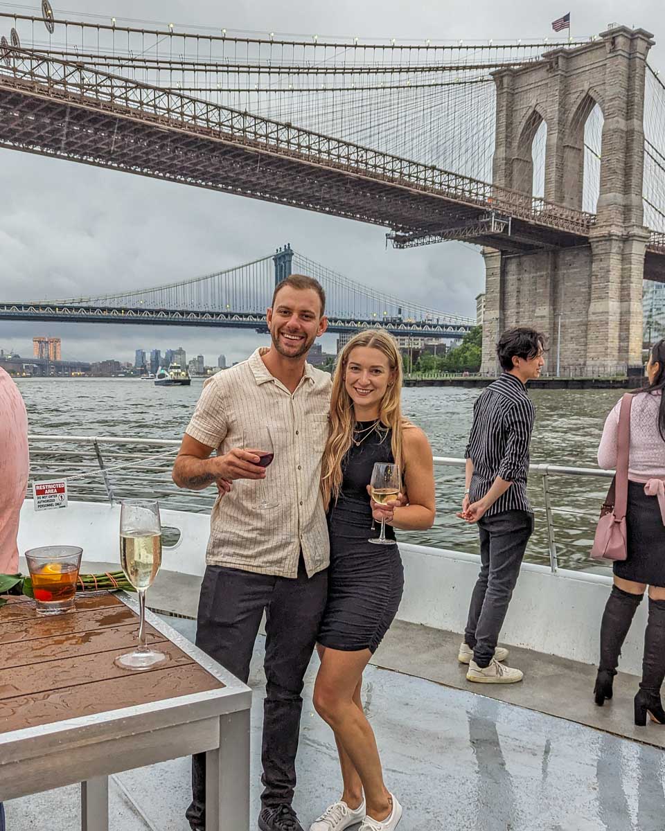 Daniel and Bailey with the Brooklyn bridge on a dinner cruise in NYC