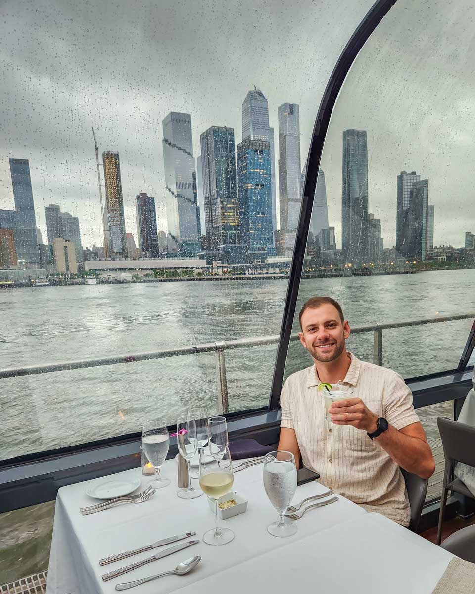 Daniel enjoys a drink while at his table on the Bateaux New York Premier Dinner Cruise
