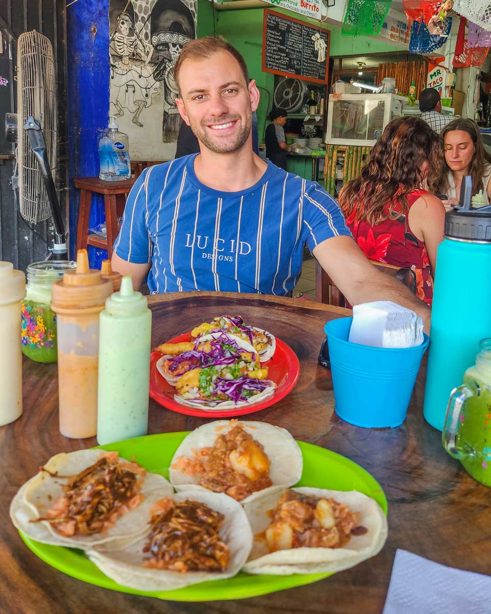 Daniel with a plate of tacos in Cancun, Mexico