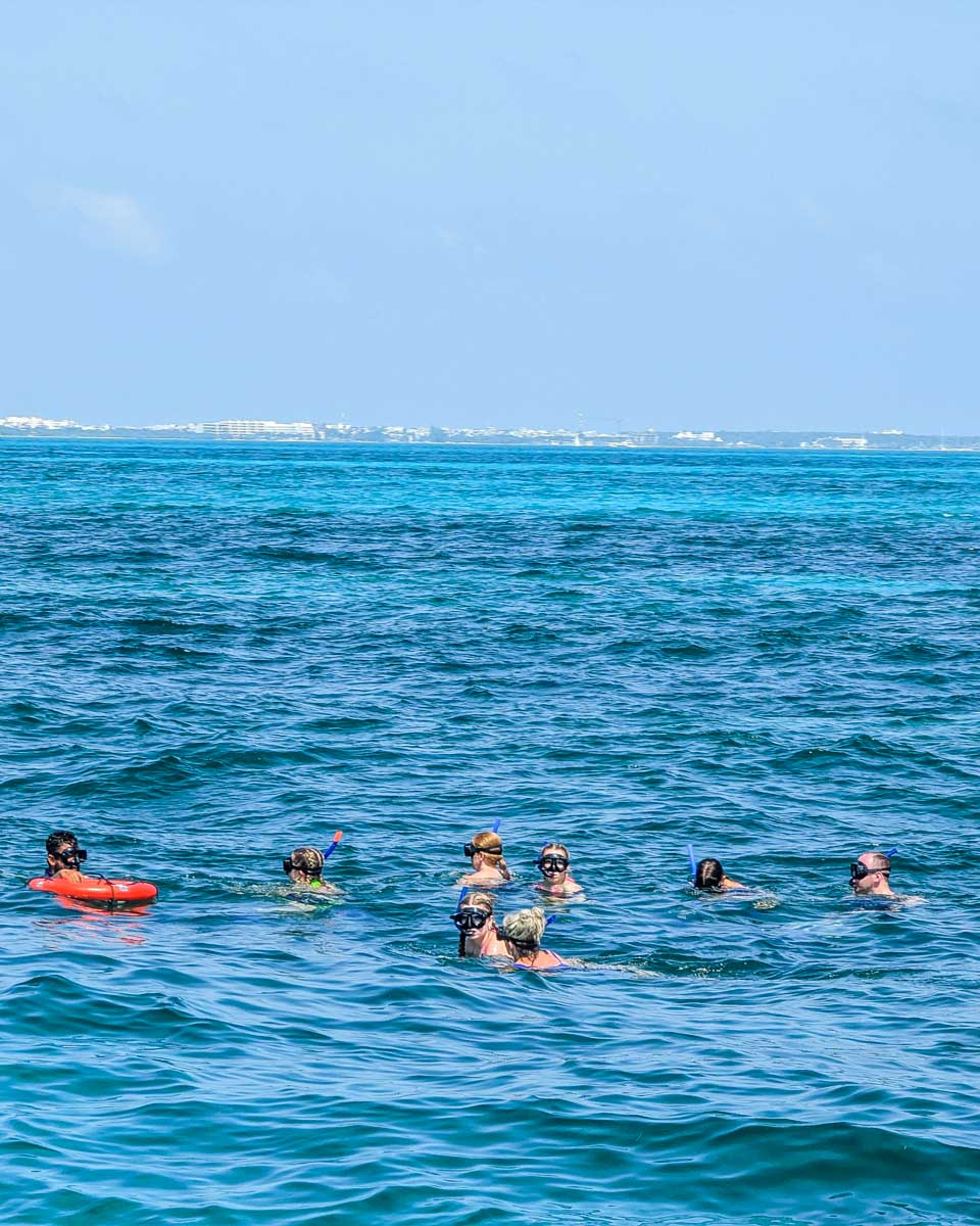 People snorkel on a sunset catamaran cruise in Cancun