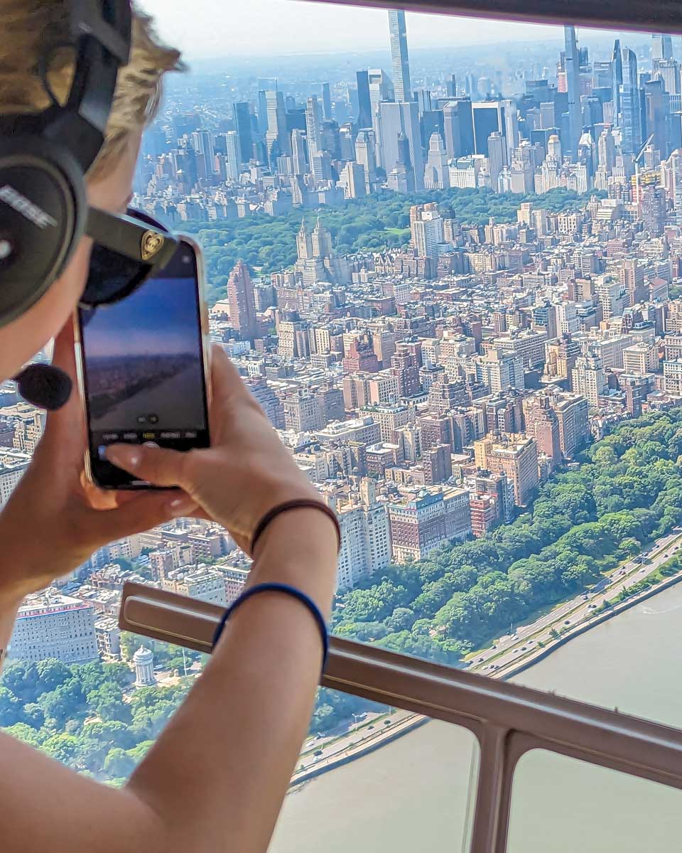 A passenger takes a photo from our New York City Helicopter ride