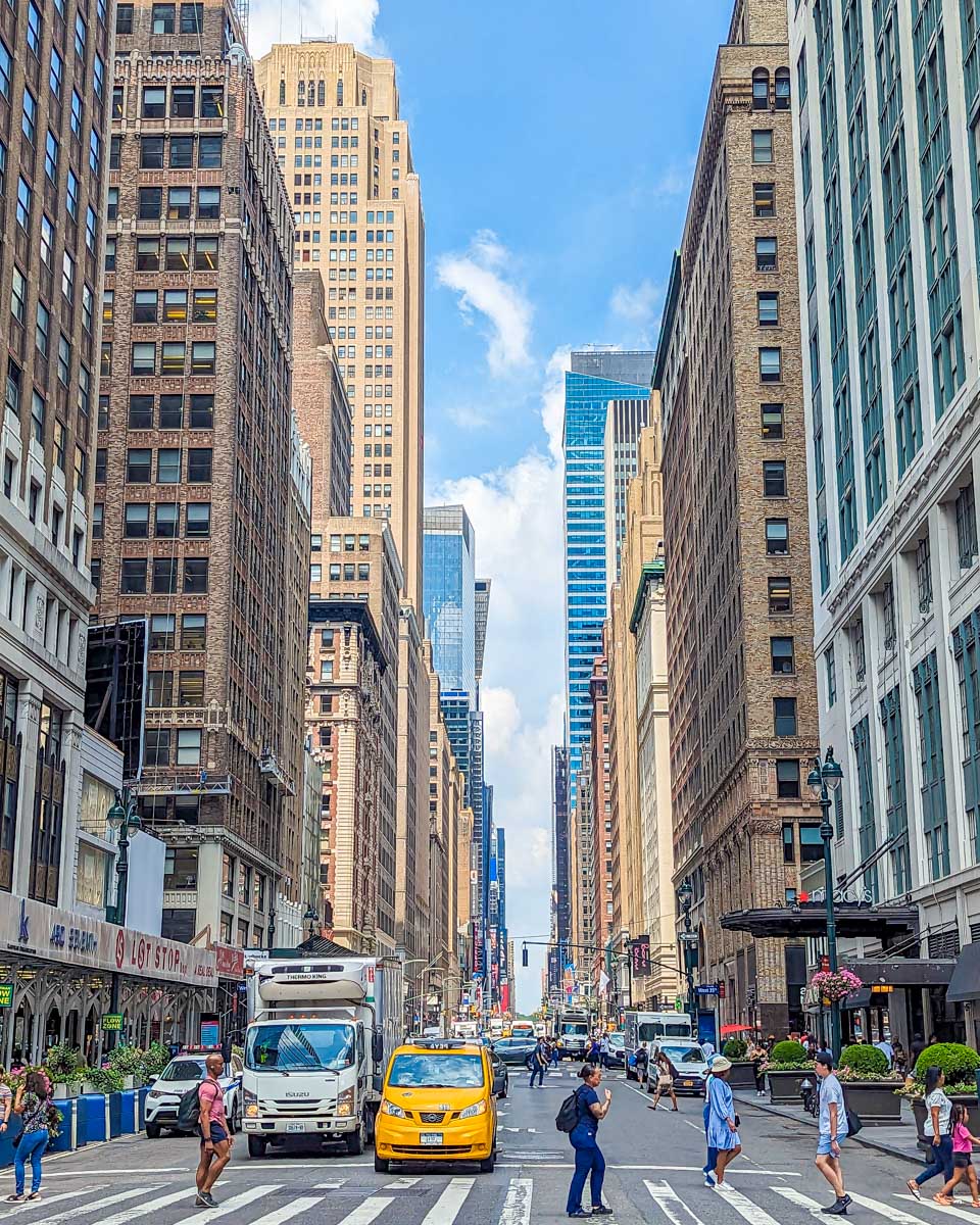 A street in New York City with the skyscrapers above