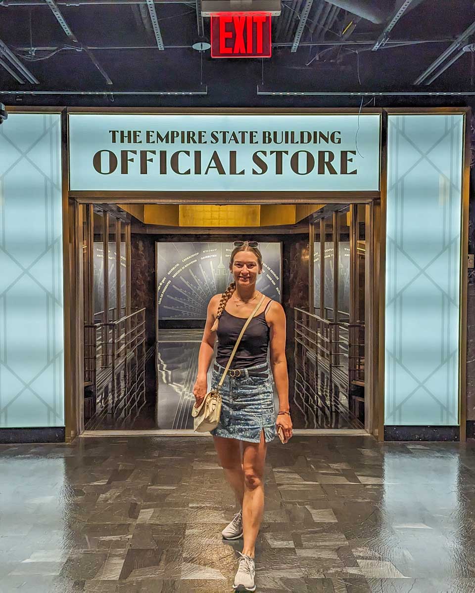 Bailey poses for a photo at the entrance to the Empire State Building official store