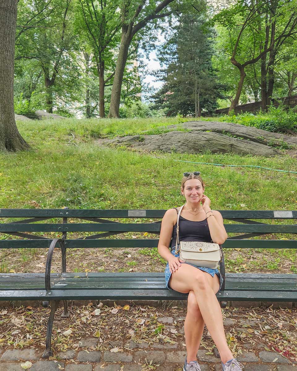 Bailey sits on a park bench in Central Park, New York City