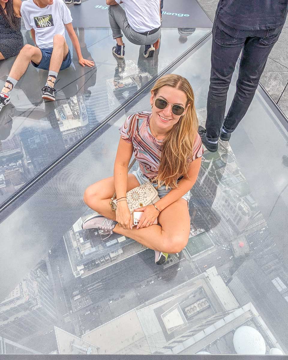 Bailey sits on the glass floor at the Edge NYC Observation deck