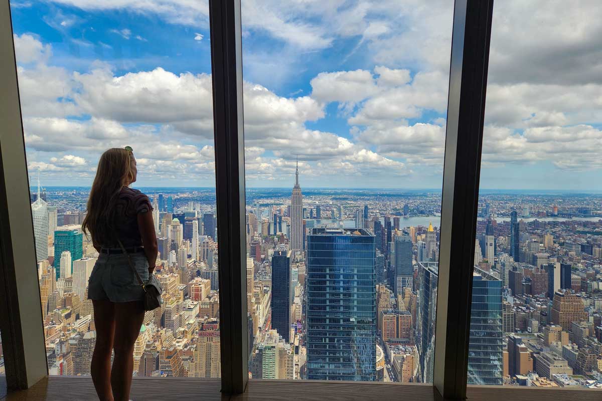 Bailey stands inside and enjoys the view of New York City from Edge NYC