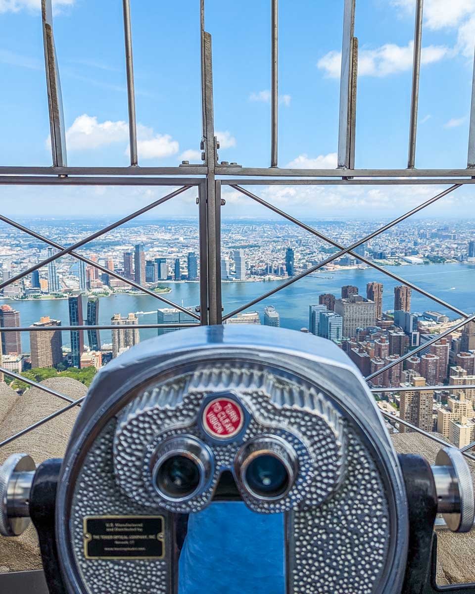 Binoculars and a view of New York City from the Empire State Building