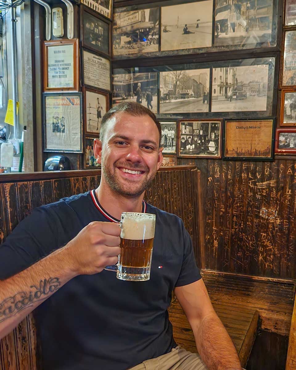 Daniel poses for a photo at McSorley's Old Ale House in New York City
