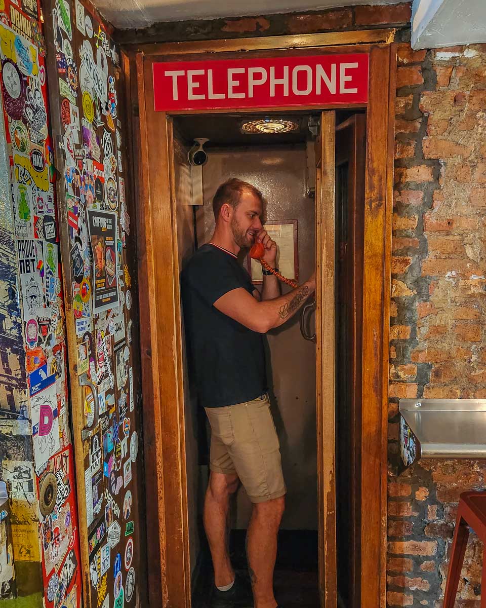 Daniel rings the phone at Please Don't Tell Speakeasy in New York City to gain entry