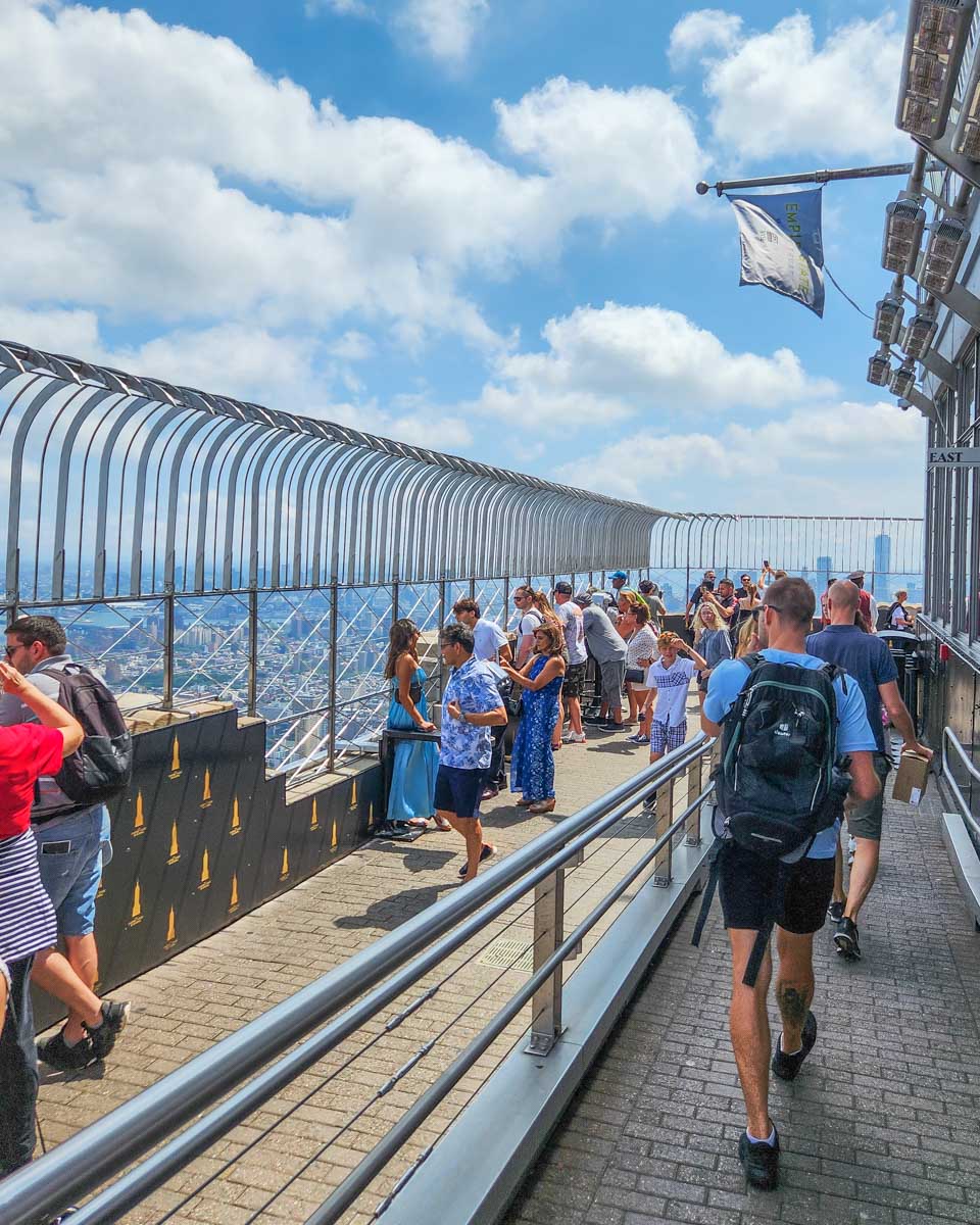 Daniel walks along the outdoor viewpoint on the 86th Floor Observatory in New York, Empire State Building